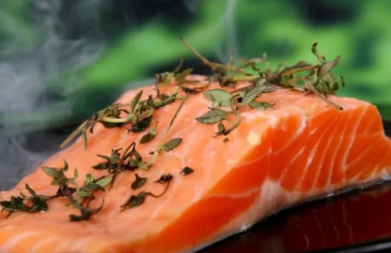Fresh salmon with herbs on top