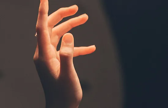 Hand raised with fingers extended
