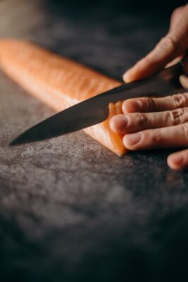 slicing raw salmon