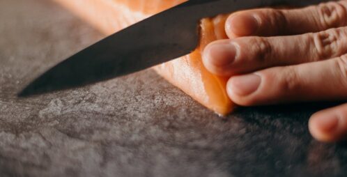 slicing raw salmon