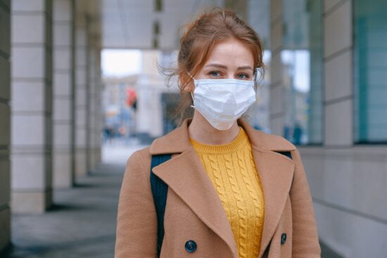masked woman on city street