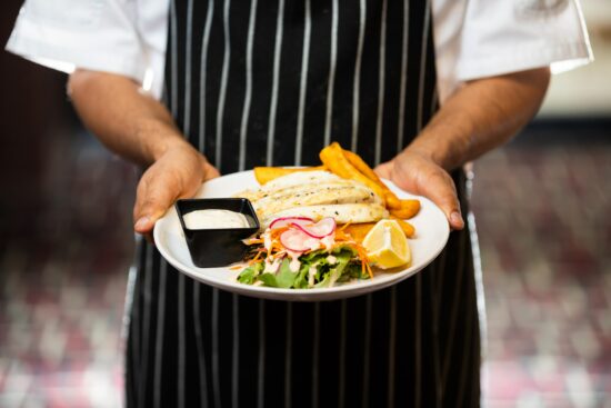 fancy fish dinner served by waiter